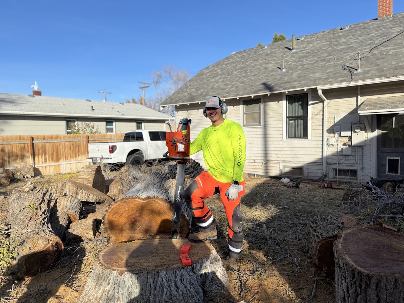 Crew member with saw on cleared stump